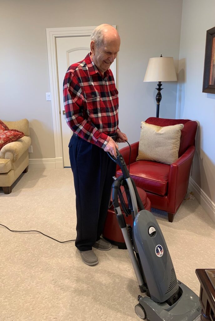 President Russell M. Nelson vacuuming.