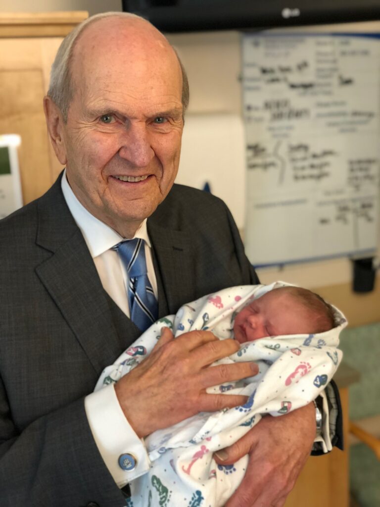 President Russell M. Nelson with one of his over 100 great grand children.